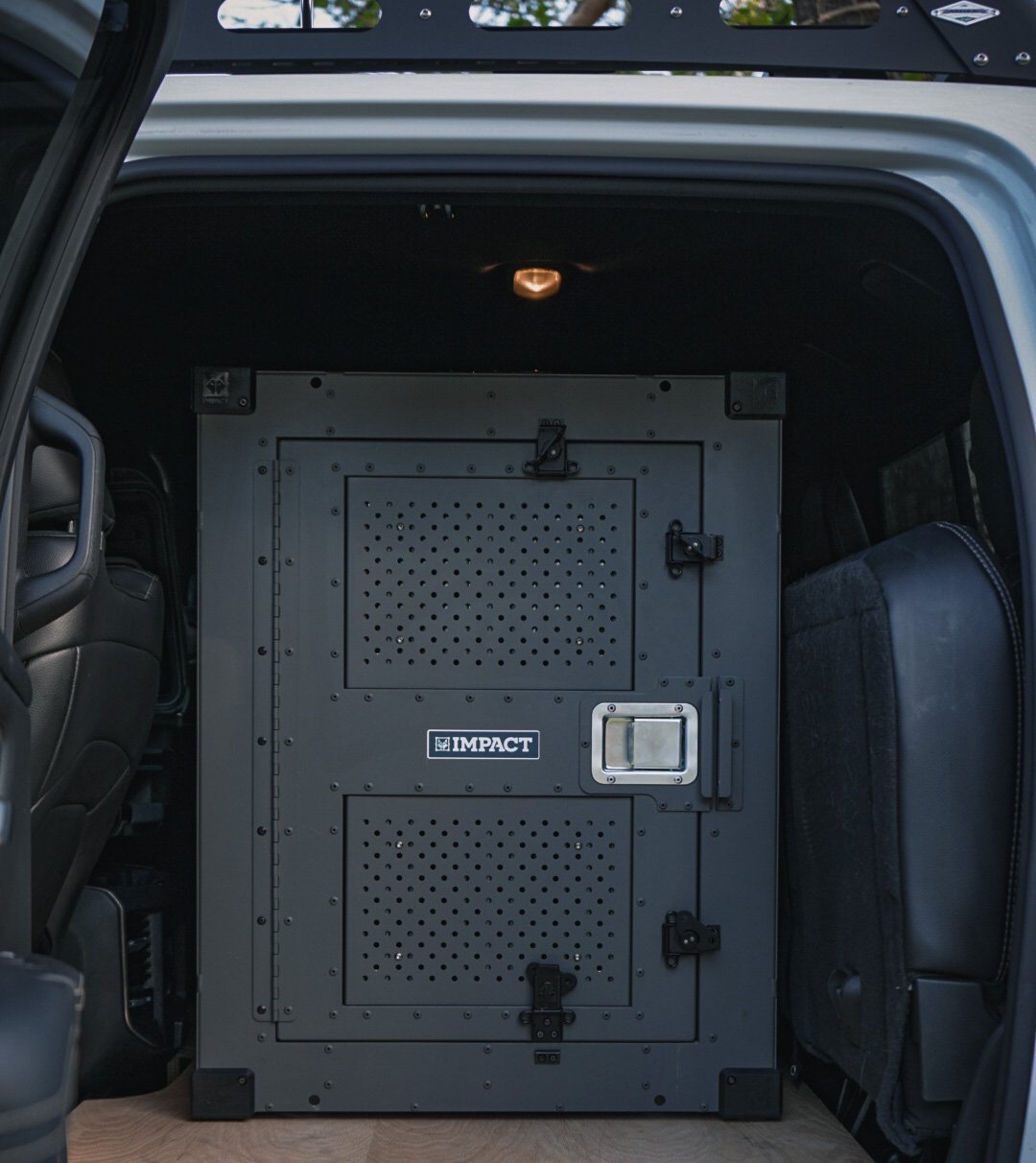 high anxiety impact dog crate with gray door guard attachment in truck